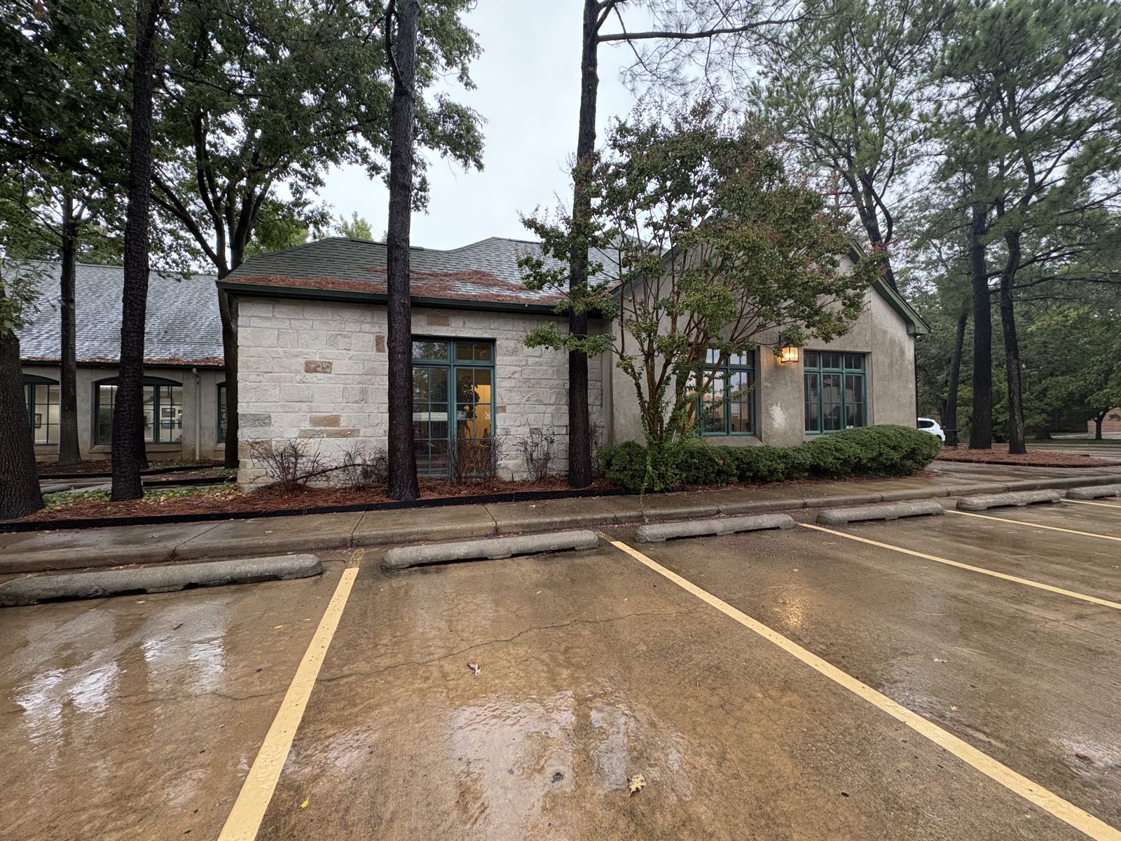 The south side of the stone building that houses Integrity Insurance Group, seen across its parking lot