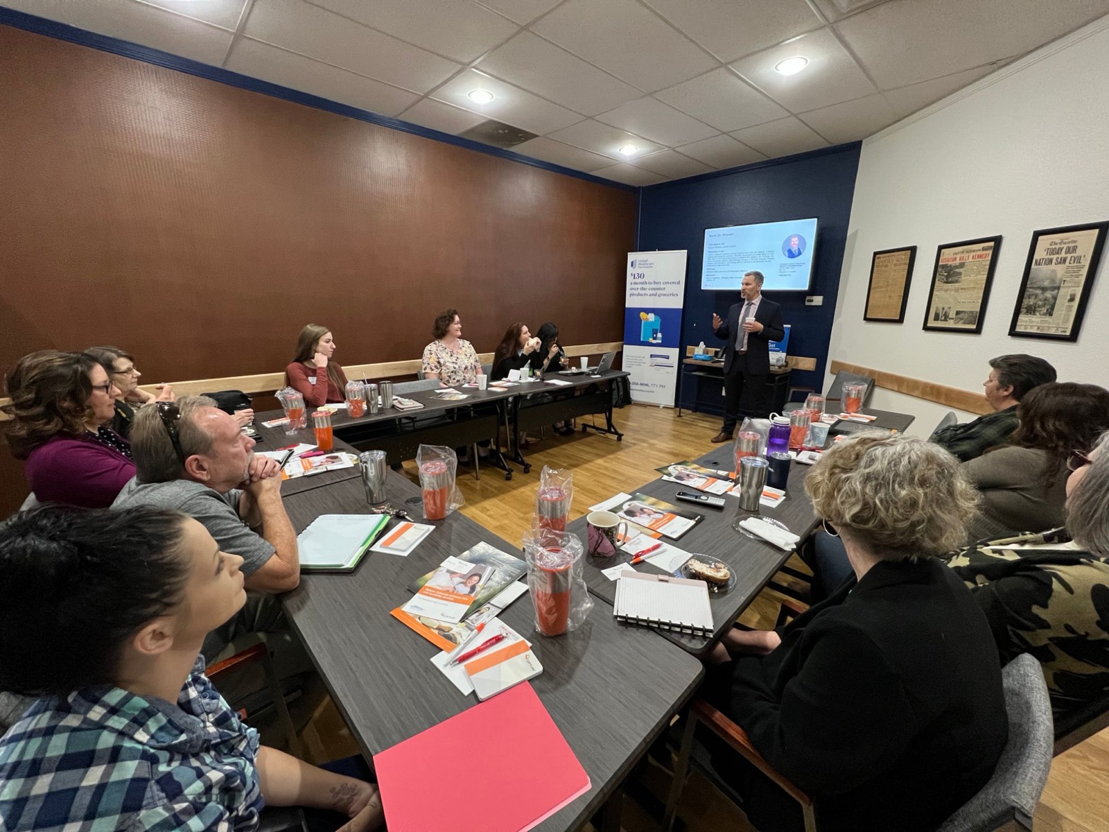 A Medicare seminar hosted by the Colorado Springs office, with a presenter at the front of a full room